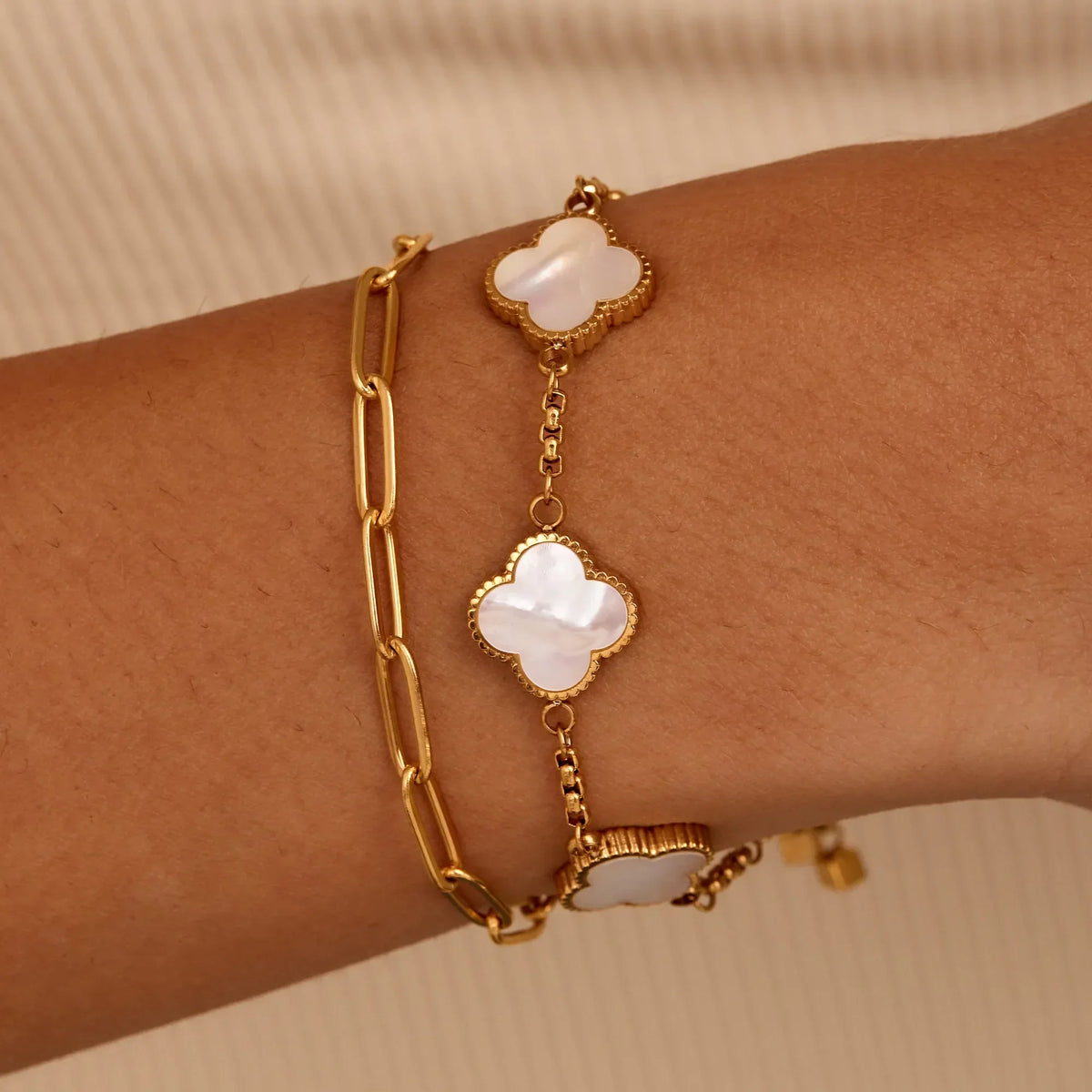 Gold pearl clover bracelet worn on wrist — Olivia Jewelry